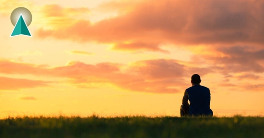 Man in the distance watching the sunset